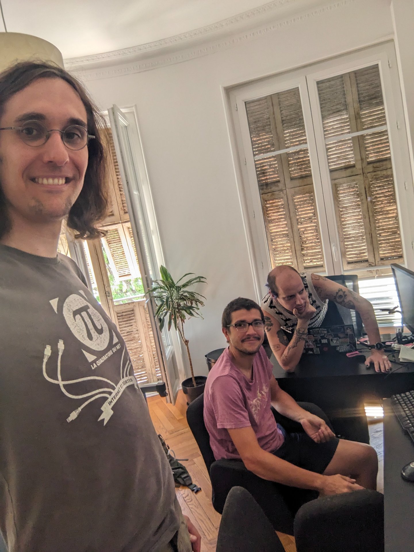 Three white dudes playing pretend-hackers. This photo will be on our biographies as the day it all started.